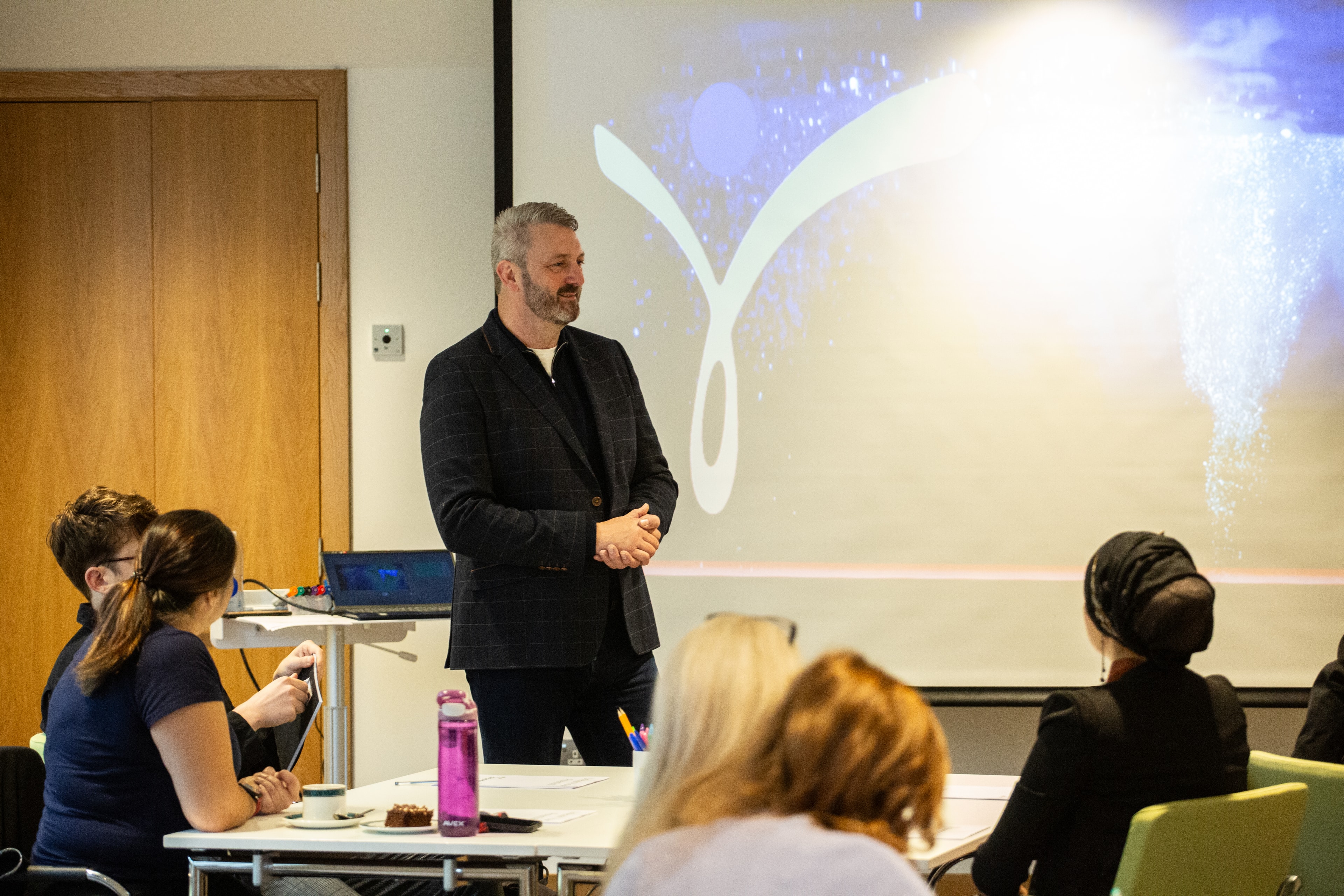 Paul teaching in front of screen