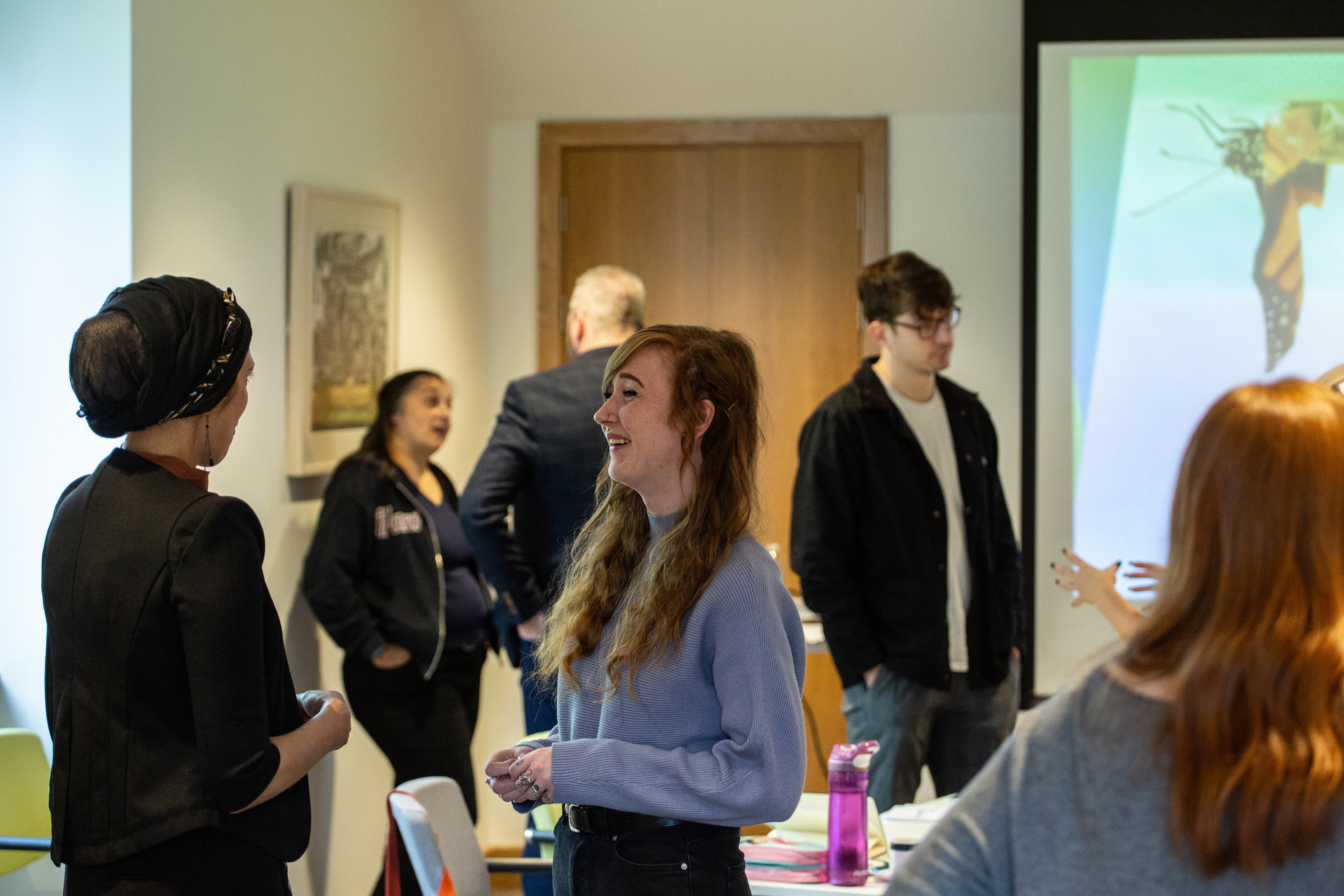 People chatting in a PKG workshop