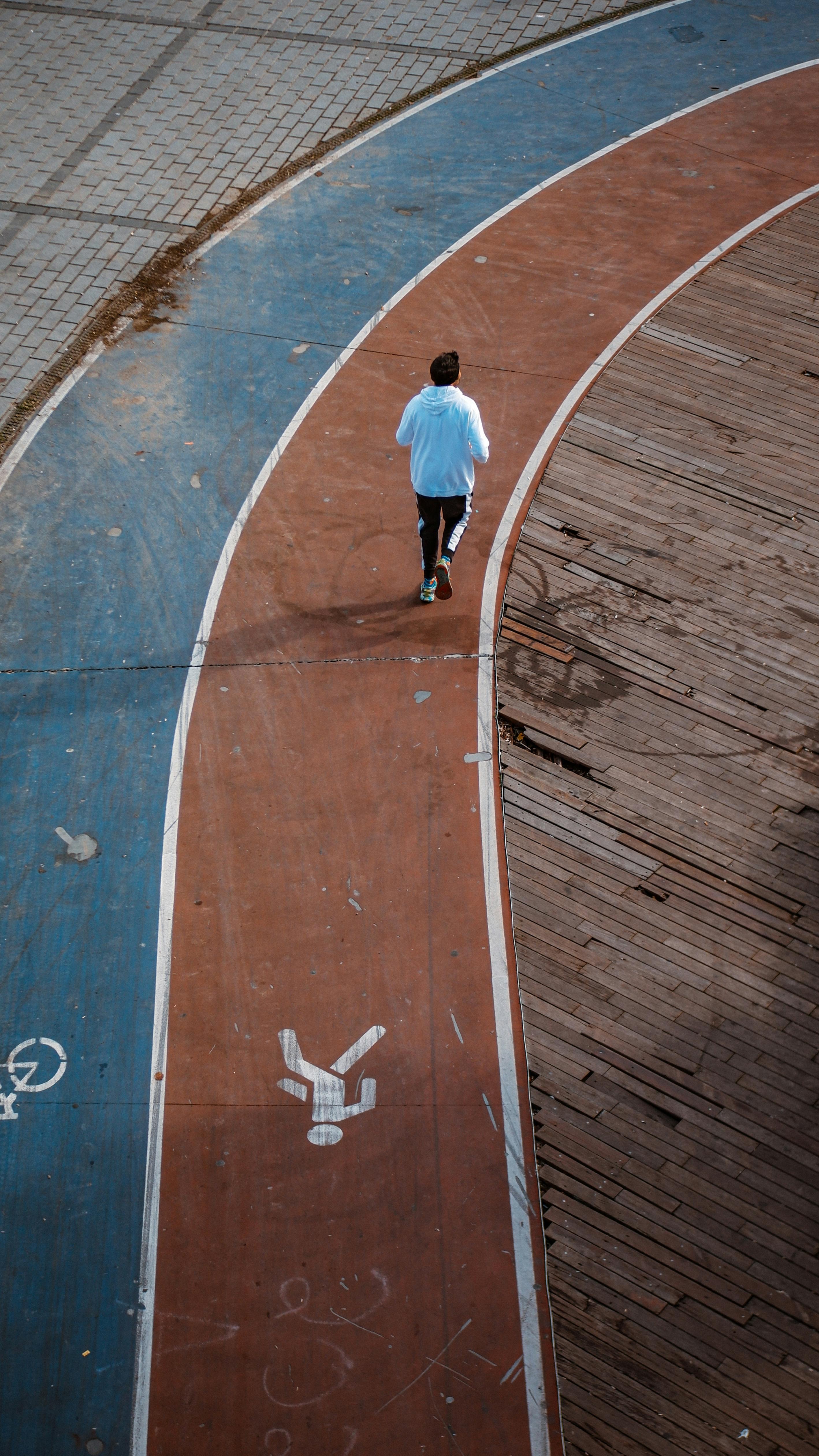Man running on worn track